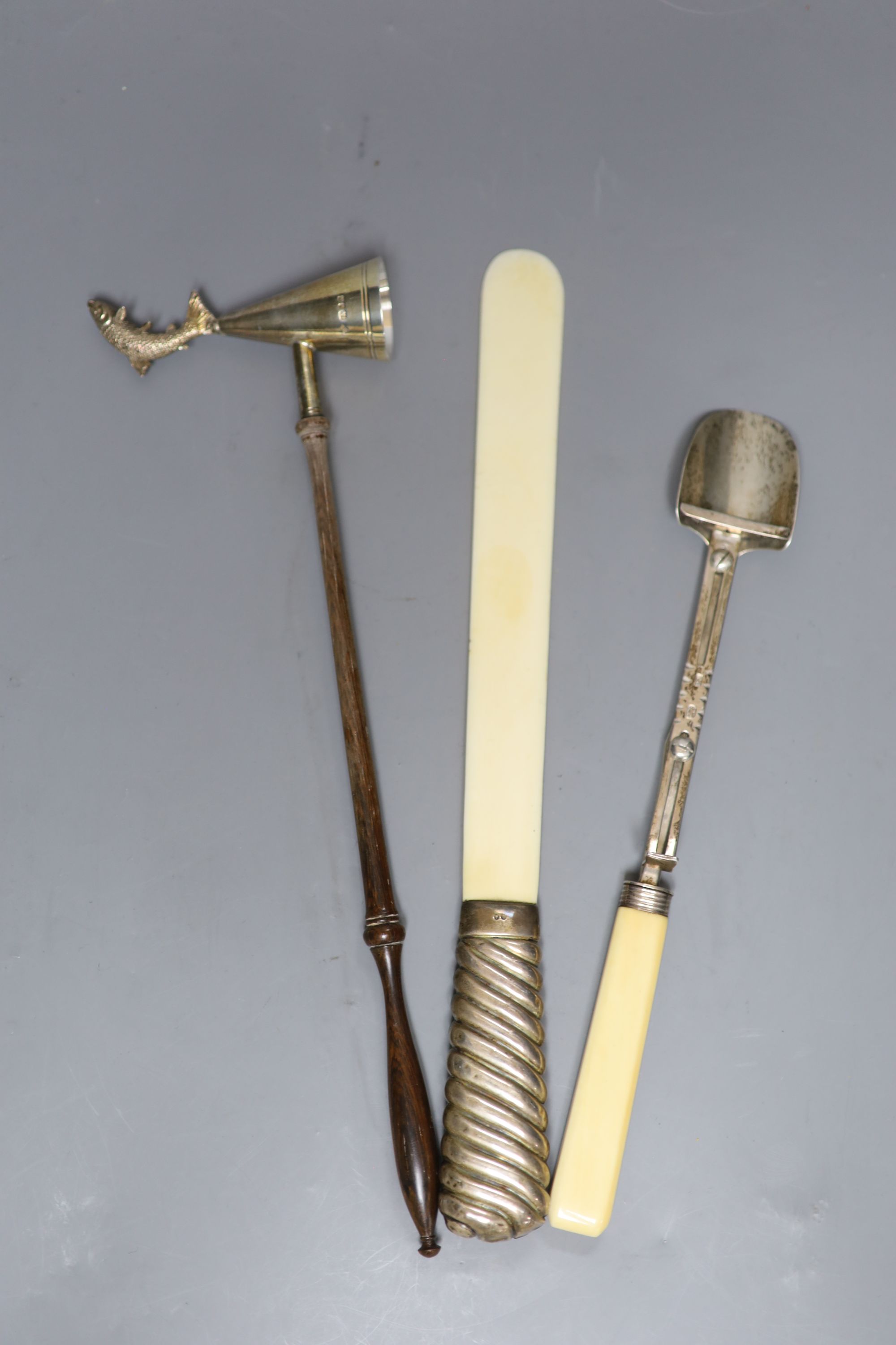 A George III ivory-handled silver cheese scoop, London, 1811, 26.4cm, a silver-handled ivory page turner and a modern silver snuffer